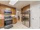 Bright kitchen featuring stainless steel appliances, tiled floor, and custom cabinets at 5609 Twin Oak Dr, Douglasville, GA 30135
