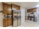 Functional kitchen with stainless steel refrigerator, tiled floor, and abundant cabinets at 5609 Twin Oak Dr, Douglasville, GA 30135