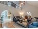 Open-concept living room with hardwood floors, arched entryways, and a view of the upper-level balcony at 5609 Twin Oak Dr, Douglasville, GA 30135