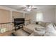 Upstairs living room boasts a ceiling fan, a neutral colored sectional couch, and large-screen TV at 5609 Twin Oak Dr, Douglasville, GA 30135