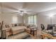 Spacious living room with natural lighting, ceiling fan, and large sectional couch at 5609 Twin Oak Dr, Douglasville, GA 30135