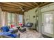 Inviting screened porch with cozy seating area, tile floors, and natural light at 5609 Twin Oak Dr, Douglasville, GA 30135