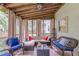 Comfortable screened porch features wicker furniture, tile floors, and backyard views at 5609 Twin Oak Dr, Douglasville, GA 30135