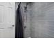 Updated bathroom shower featuring gray tiled walls and a dual shower head at 1421 Peachtree Ne St # 401, Atlanta, GA 30309