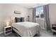 Bright bedroom featuring a bed, side table with lamp, and light gray flooring at 1421 Peachtree Ne St # 401, Atlanta, GA 30309