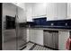 Well-lit kitchen features stainless steel appliances and a striking blue tile backsplash at 1421 Peachtree Ne St # 401, Atlanta, GA 30309