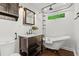 This is a bathroom with a tub, natural light, a marble countertop, and black hardware at 1734 8Th St, Brookhaven, GA 30341
