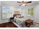 This is a bedroom with a ceiling fan, wood floors, shutters, and an area rug at 1734 8Th St, Brookhaven, GA 30341