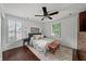 This is a bedroom with a ceiling fan, wood floors, shutters, and an area rug at 1734 8Th St, Brookhaven, GA 30341