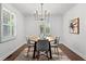 Elegant dining room with a modern chandelier, hardwood floors, and white trim at 1734 8Th St, Brookhaven, GA 30341