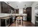 Modern kitchen with dark cabinets, granite countertops, stainless steel appliances, and hardwood floors at 1734 8Th St, Brookhaven, GA 30341