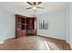 Bedroom featuring hardwood floors, built-in bookshelves and large window at 1800 Clairmont #428 Lk # A428, Decatur, GA 30033