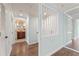 Hallway featuring hardwood floors, mirrored wall, and decorative elements at 1800 Clairmont #428 Lk # A428, Decatur, GA 30033