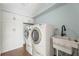 Bright laundry room with full size washer and dryer, storage, and a utility sink at 1800 Clairmont #428 Lk # A428, Decatur, GA 30033