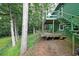 Exterior shot of a green home with a deck and tree-lined backyard at 3743 Wyntuck Nw Cir, Kennesaw, GA 30152