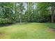 Expansive, green backyard surrounded by a lush forest, offering privacy and natural beauty for outdoor enjoyment and relaxation at 3743 Wyntuck Nw Cir, Kennesaw, GA 30152
