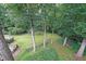 Large, green backyard with mature trees and a view of the deck at 3743 Wyntuck Nw Cir, Kennesaw, GA 30152