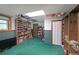 Finished basement featuring custom built-in bookshelves with green carpet and lots of storage space at 3743 Wyntuck Nw Cir, Kennesaw, GA 30152