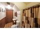 Compact bathroom includes a toilet, sink, and a shower with a patterned curtain at 3743 Wyntuck Nw Cir, Kennesaw, GA 30152