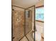 Bathroom featuring a tiled shower with a glass door, a toilet, and a window at 3743 Wyntuck Nw Cir, Kennesaw, GA 30152