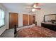 Bedroom with carpet, a ceiling fan, a dresser, and multiple closets at 3743 Wyntuck Nw Cir, Kennesaw, GA 30152