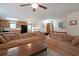 Spacious living room with a large sofa, wooden coffee table, and an open view to the kitchen area, bright natural light at 3743 Wyntuck Nw Cir, Kennesaw, GA 30152