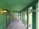 View of a cozy screened porch with a swing, painted in shades of green, perfect for relaxing outdoors at 3743 Wyntuck Nw Cir, Kennesaw, GA 30152