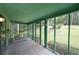 Inviting screened porch featuring a porch swing, offering a serene outdoor living space with views of the yard at 3743 Wyntuck Nw Cir, Kennesaw, GA 30152