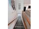 Carpeted staircase leads to the lower level of the home with wooden banister at 3743 Wyntuck Nw Cir, Kennesaw, GA 30152