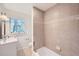 Bright bathroom features updated tile surround, classic vanity, and large window at 4089 Menlo Dr, Tucker, GA 30084