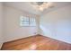 Sunlit bedroom features gleaming hardwood floors and a ceiling fan at 4089 Menlo Dr, Tucker, GA 30084