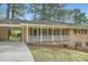 Traditional brick home with a covered porch, window shutters, and a well-maintained lawn at 4089 Menlo Dr, Tucker, GA 30084