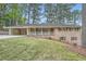 Classic brick ranch-style home with shutters and a covered porch on a lush, grassy lot at 4089 Menlo Dr, Tucker, GA 30084