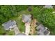 Aerial view of a property showcasing its lush green surroundings, well-manicured yard, and proximity to neighboring homes at 4987 Day Lily Nw Way, Acworth, GA 30102