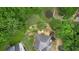 Aerial view of a home highlighting the landscaped backyard, patio, and surrounding greenery at 4987 Day Lily Nw Way, Acworth, GA 30102