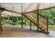 Back porch with wooden stairs and concrete flooring, offering outdoor access and potential at 4987 Day Lily Nw Way, Acworth, GA 30102