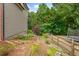 Landscaped backyard featuring a garden area, a wooden fence, and an installed trampoline at 4987 Day Lily Nw Way, Acworth, GA 30102