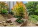 Multi-level backyard featuring lush landscaping, brick retaining walls, and stairs to the upper deck at 4987 Day Lily Nw Way, Acworth, GA 30102