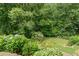 Lush backyard and garden featuring a variety of flowers, shrubs, and mature trees, creating a private oasis at 4987 Day Lily Nw Way, Acworth, GA 30102