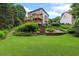 Expansive backyard featuring a well-maintained lawn and multi-level deck overlooking beautifully landscaped surroundings at 4987 Day Lily Nw Way, Acworth, GA 30102