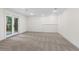 Spacious finished basement featuring neutral carpet and a door leading to the outside at 4987 Day Lily Nw Way, Acworth, GA 30102