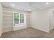Finished basement features neutral colors, a view to the outside, and convenient built-in shelving at 4987 Day Lily Nw Way, Acworth, GA 30102