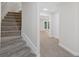 Basement access with carpeted stairs leading to a finished room and outside exit at 4987 Day Lily Nw Way, Acworth, GA 30102