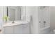 Well-lit bathroom with a shower/tub combo, vanity with sink, and fresh towels at 4987 Day Lily Nw Way, Acworth, GA 30102