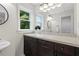 Modern bathroom with dark wood cabinets, large mirror, and bright lighting at 4987 Day Lily Nw Way, Acworth, GA 30102