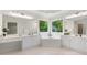 Bright bathroom featuring double vanities, a soaking tub with a garden view, and neutral tile floors at 4987 Day Lily Nw Way, Acworth, GA 30102
