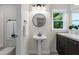 Bathroom featuring a pedestal sink, modern lighting, and a window at 4987 Day Lily Nw Way, Acworth, GA 30102