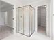 Bathroom with tiled shower, white walls, and doorways to the bedroom and a walk-in closet at 4987 Day Lily Nw Way, Acworth, GA 30102
