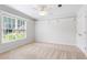 Bright bedroom with neutral carpet, a ceiling fan, shelving, and natural light from the window at 4987 Day Lily Nw Way, Acworth, GA 30102