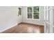 Bedroom featuring hardwood floors, a rear-facing door, and a corner window at 4987 Day Lily Nw Way, Acworth, GA 30102